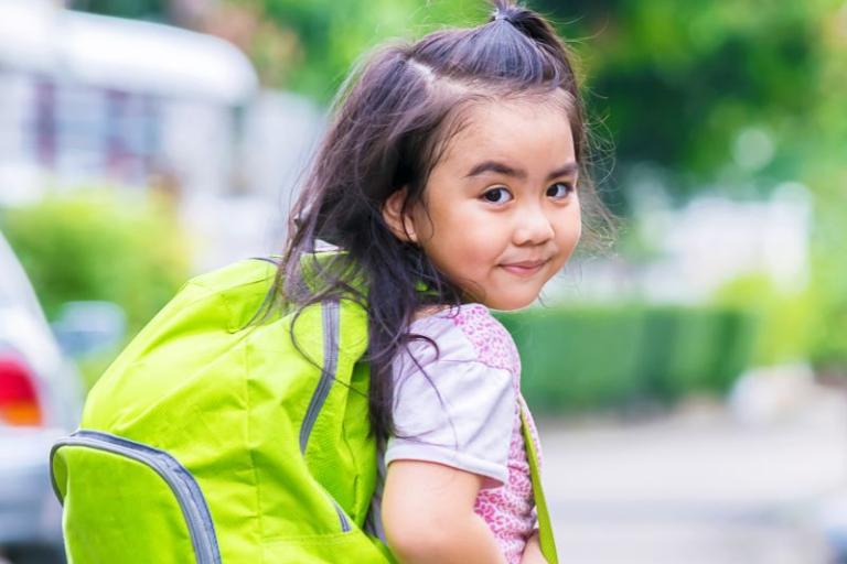 Young student smiling with a backpack