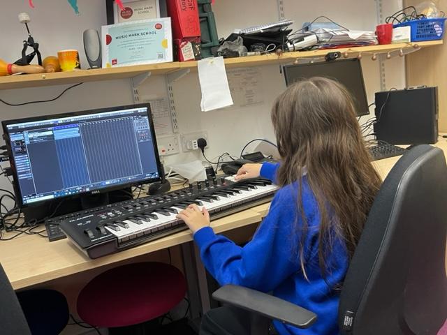 image of young pupil working at a computer with a keyboard