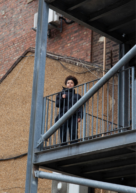 image of young person standing on an outdoor staircase