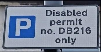 Parking sign showing a P in a blue square and a permit bay number