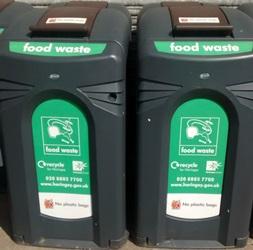 Large black communal food waste bin with lid