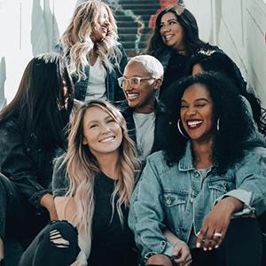 6 women talking and laughing