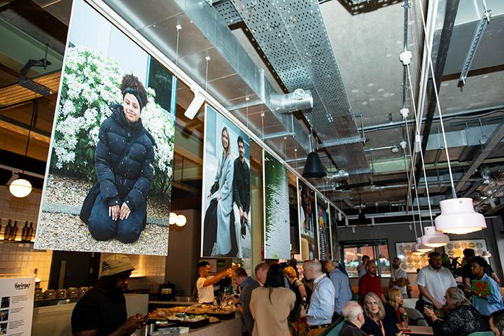 Image of the Shaping Wood Green launch event with several large photographs