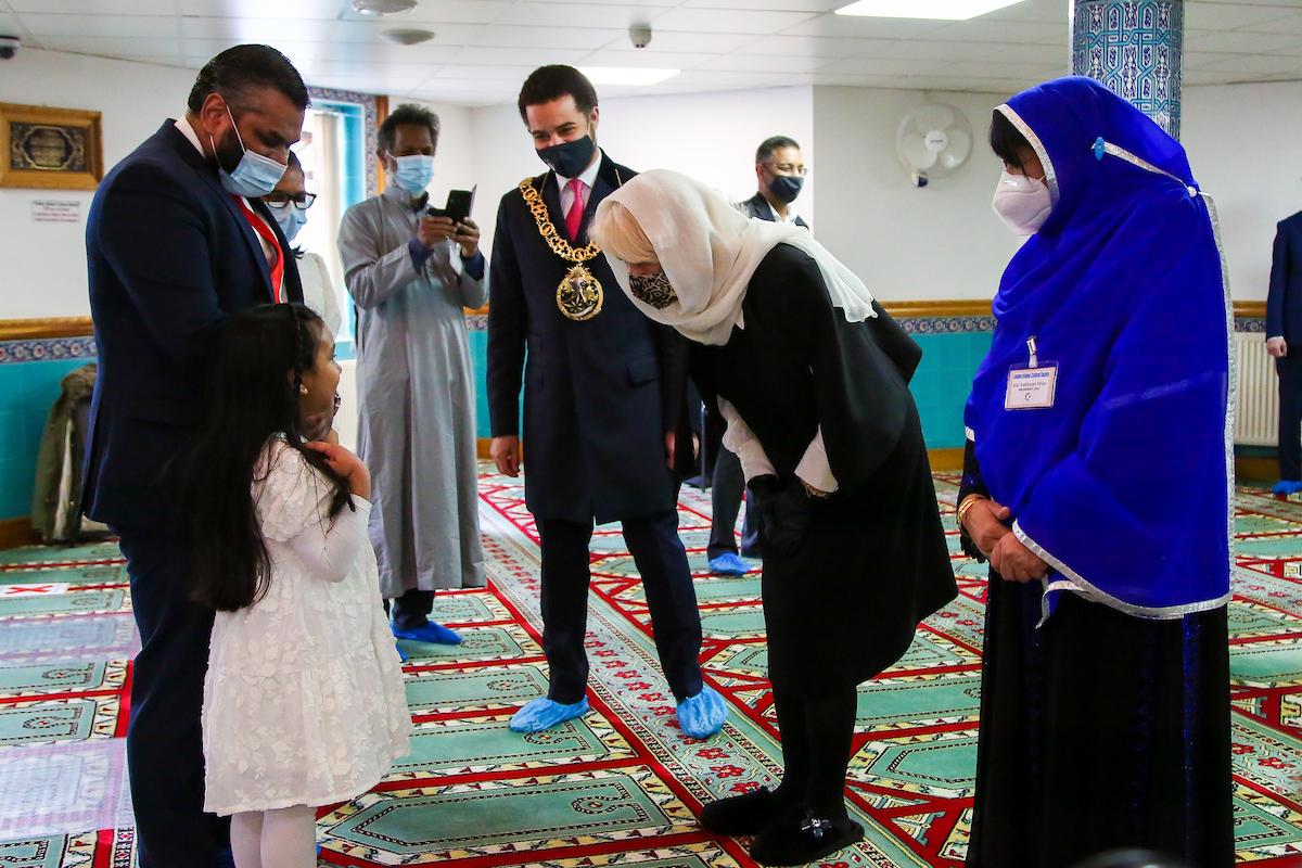 Her Royal Highness the Duchess of Cornwall chats to a young girl during her visit to Wightman Road Mosque.