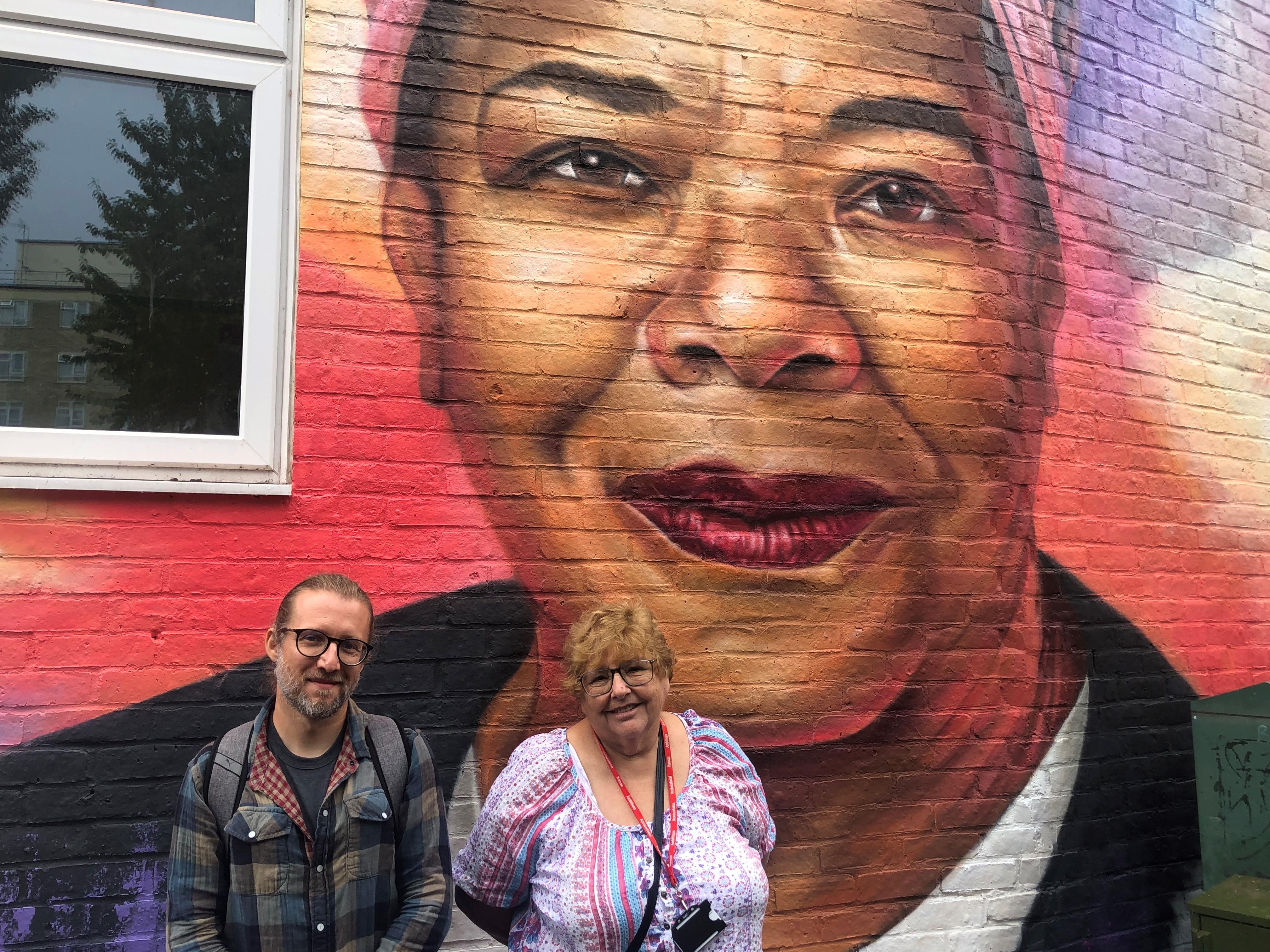 Cllr Zena Brabazon with the renowned artist WOSKerski in front of the Maya Angelou mural at the family centre that bears the late poet's name.