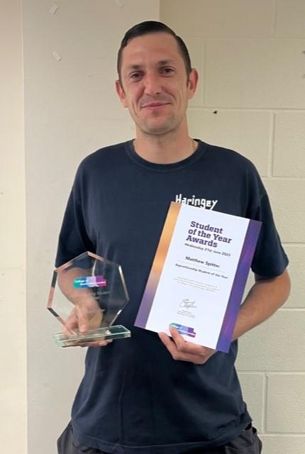The pic is of a smiling Matthew proudly holding his award and certificate.