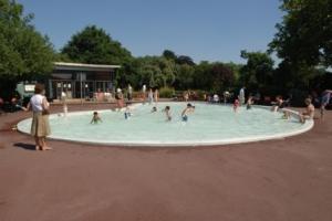 Children playing in park paddling pool