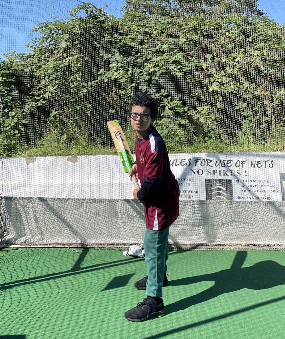 image of young person holding a cricket bat